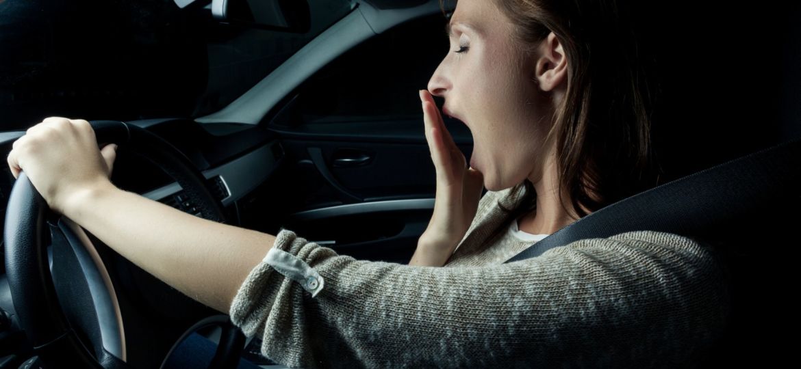 woman yawning while driving